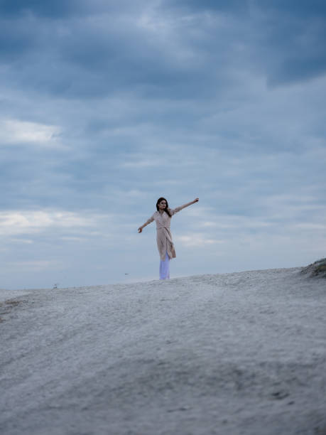 istock beautiful woman in coat sand summer elegant style 2138712037