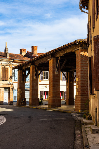 Market hall built in red bricks, in the middle of the medieval village of Rieux-Volvestre