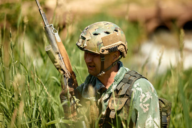 istock Full military experience - One day commando - running through the water with automatic rifle replica 2138748907