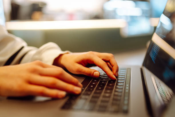 istock Close-up of hands working on a laptop keyboard. 2138763554