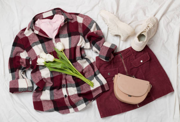 istock Flat lay with trendy spring outfit and flowers on white sheet background 2138764617