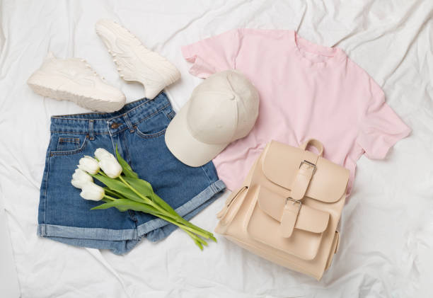 istock Flat lay with trendy spring outfit and flowers on white sheet background 2138764619