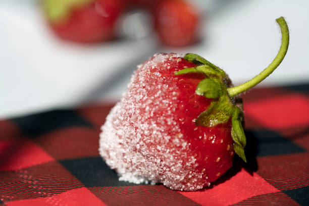 Light background with strawberry berry on white saucer, selective focus, horizontal format