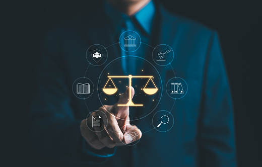 Legal Professional with Justice Icons. A suited legal professional touches virtual icons symbolizing law, justice, and legal services. business legislation, Notary public, legal advice online, Lawyer