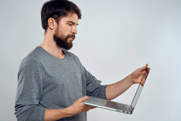 istock Emotional man holding a laptop success modern style work light background 2138843567