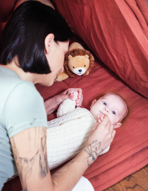 istock Mother and daughters having fun in tent at home 2138856576
