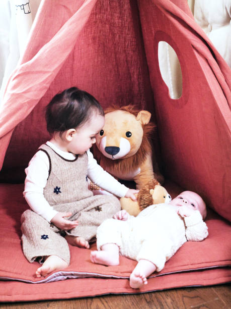 istock Two infant sisters having fun in tent at home 2138863371