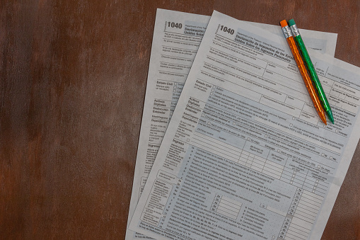 Two Spanish US tax forms for paying annual taxes on flat lay