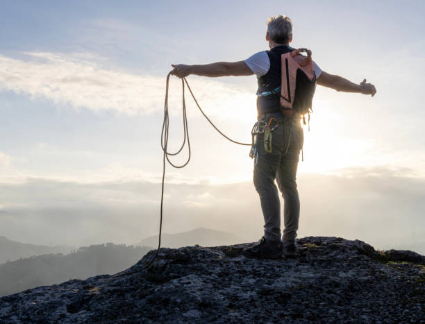 istock Mature climber stands on mountain with rope 2138866508