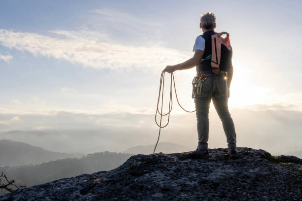 istock Mature climber stands on mountain with rope 2138866509