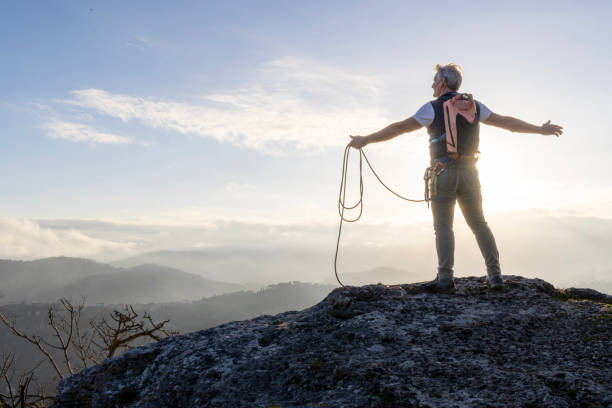 istock Mature climber stands on mountain with rope 2138867085