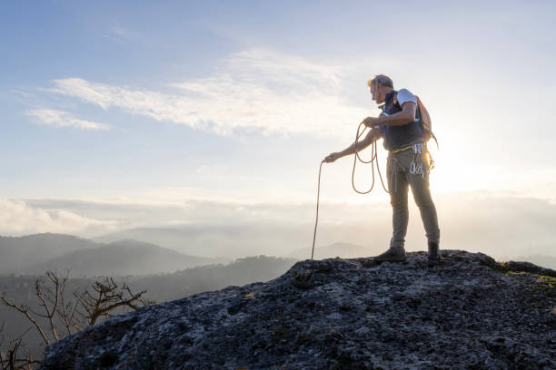 istock Mature climber stands on mountain with rope 2138867087