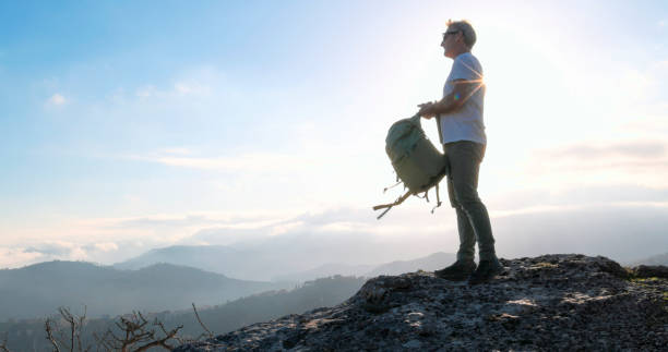 istock Mature hiker arrives on mountain top at sunset 2138867417
