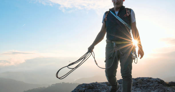 istock Mature climber stands on mountain with rope 2138867510