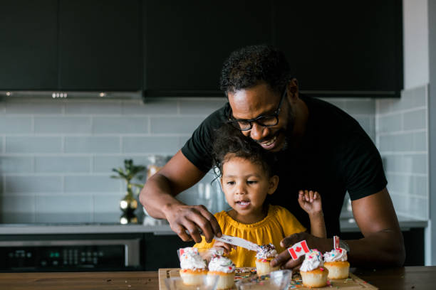 istock Father and daughter decorate cupcakes while celebrating Canada Day at home 2138868205