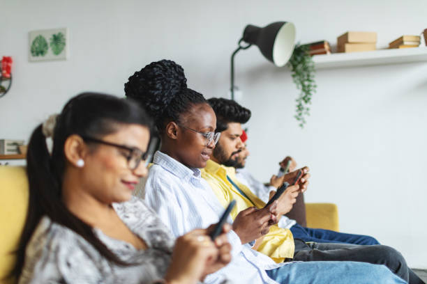 istock Friends sitting with mobiles at dorm 2138868844