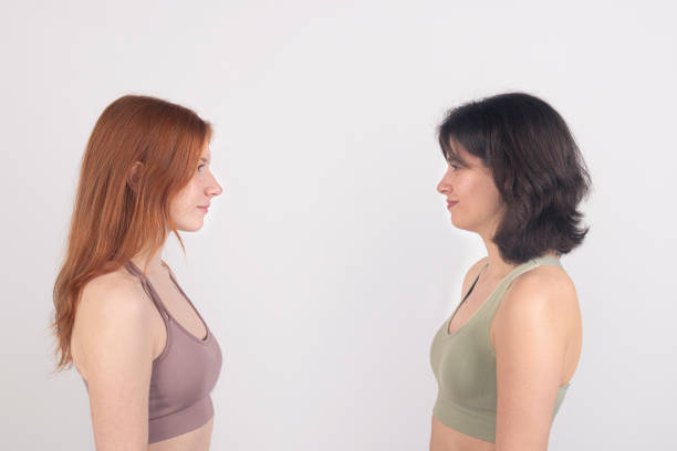 istock Two women facing each other against a white background, displaying neutral expressions. 2138879380