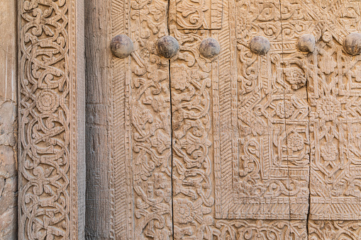 Khiva, Xorazm Region, Uzbekistan, Central Asia. An old carved wooden door in Khiva.