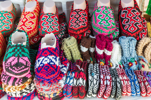 Khiva, Xorazm Region, Uzbekistan, Central Asia. Colorful hand knit slipper for sale in Khiva.