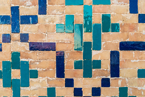 Bukhara, Uzbekistan, Central Asia. Decorative tiles on a brick wall at the Kalan Mosque in Bukhara.