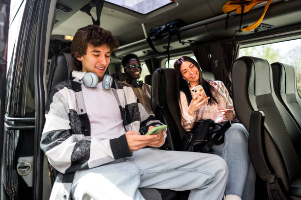 istock Friends sitting on the bus and using their phones 2138896766