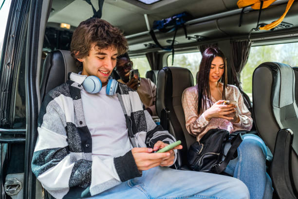 istock Friends sitting on the bus and using their phones 2138898336