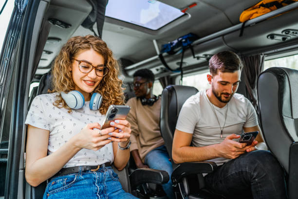 istock Friends using mobile phones while sitting on the bus 2138898885
