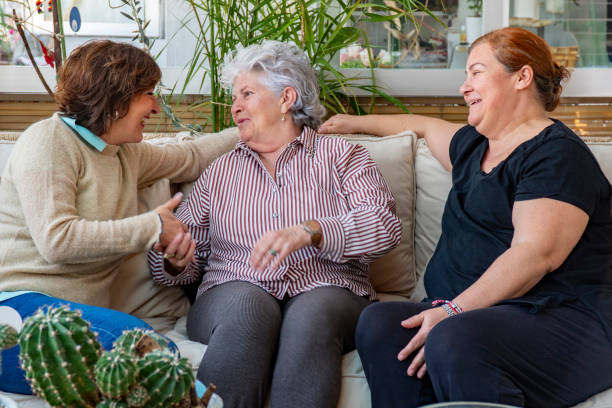 istock Three woman chatting laughing on the sofa. 2138904209
