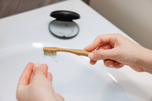istock Woman's hand holding invisible aligners. 2138905373