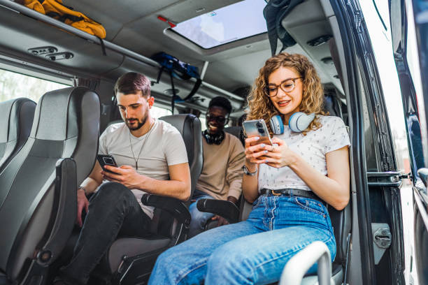 istock Friends using mobile phones while sitting on the bus 2138906453