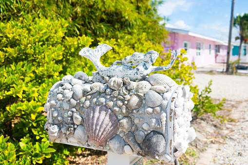 Maritime mailbox decorated with a mermaid and shells.