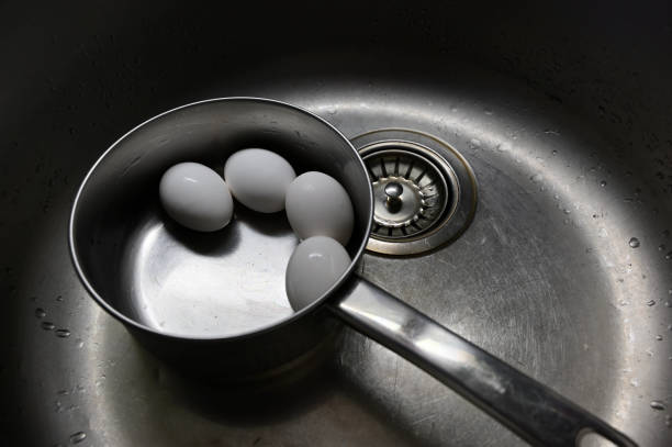 istock boiled chicken eggs in a metal pot in the sink 2138939445