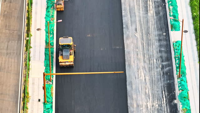 Aerial view of asphalt road construction scene