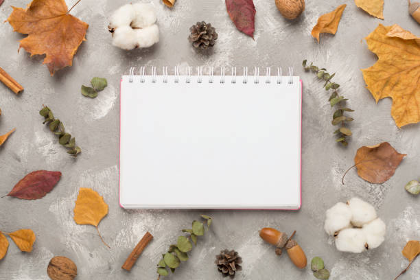 istock Autumn leaves with notebook on concrete background, top view 2138955715