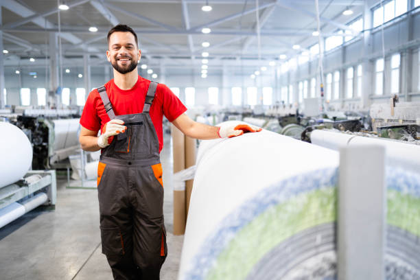 istock Textile factory worker standing by industrial machine producing carpets. 2138961807