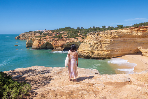 Nazaré, Portugal - April 03 2024: Tourist admiring the cliffs and cave near Benagil in Algarve region, Portugal