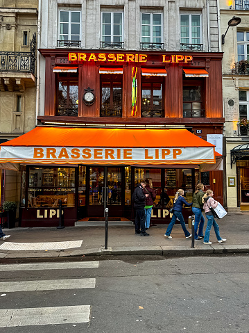 Paris, France - 20.02.2024. Street view of Boulevard Saint-Germain-des-Pres and Brasserie Lipp, a famous historical traditional Parisian brasserie.