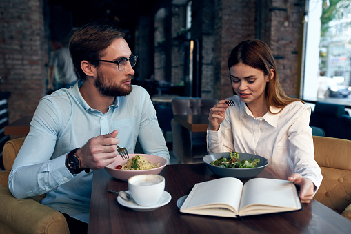 business man and woman breakfast in a cafe communication work colleagues. High quality photo