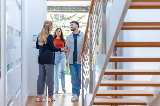 istock Real estate agent showing a young couple a new house. 2139010213