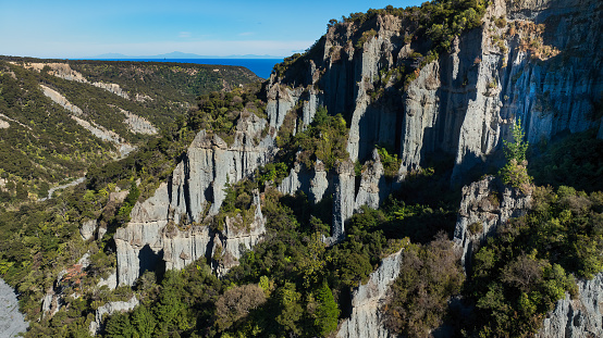 The Pūtangirua Pinnacles are a geological formation near Ngawi in Southern Wairarapa.  The Lord of the Rings: The Return of the King was filmed on location here, If you look carefully you can see the Southern Alps in the South Island on the horizon on the other side of Cook Strait