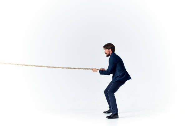 istock man with rope in hand on light background business finance advertising model 2139072804