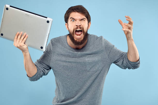 istock Bearded man laptop in hand internet wireless technology emotions blue background 2139107314