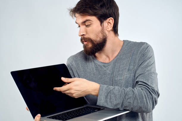 istock A man in a gray sweater with a laptop hands lifestyle technology communication internet work 2139108339