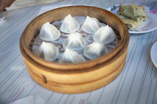 Street food: fresh, hot soup dumplings being steamed to order inside bamboo baskets.