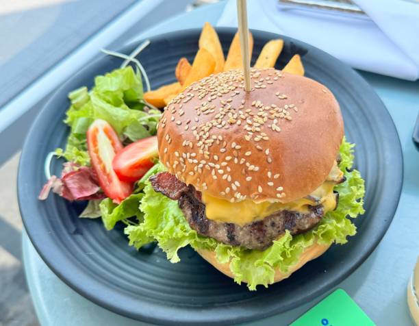 istock Beef burger, french fries, salad 2139133922