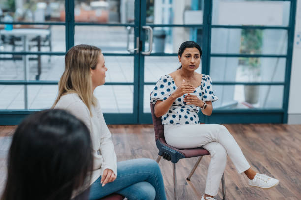 istock Young adult woman sharing life experience in group therapy 2139198973