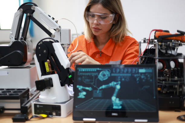 istock Portrait of a young female engineer confidently operating a robotic arm in a high-tech industrial laboratory facility. 2139210250
