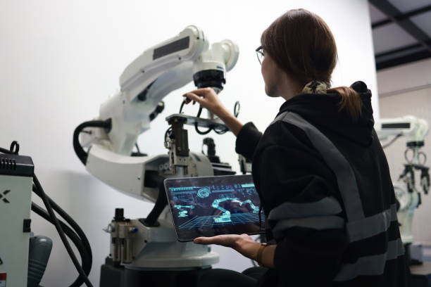 Portrait of skilled welding engineers mastering robotics welding for an efficient automotive parts production line.