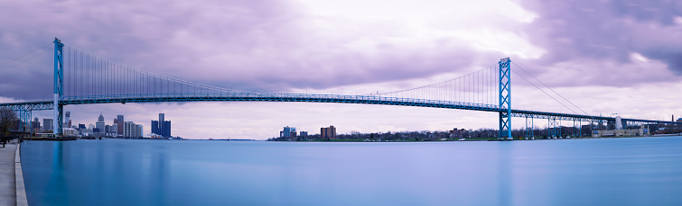 The Ambassador Bridge across the Detroit River connecting Detroit, Michigan in the United States with Windsor, Ontario in Canada, a panoramic long-exposure photography