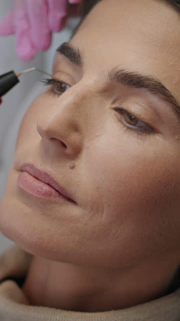 Innovative procedure removing wrinkles in cosmetology clinic vertical close up.